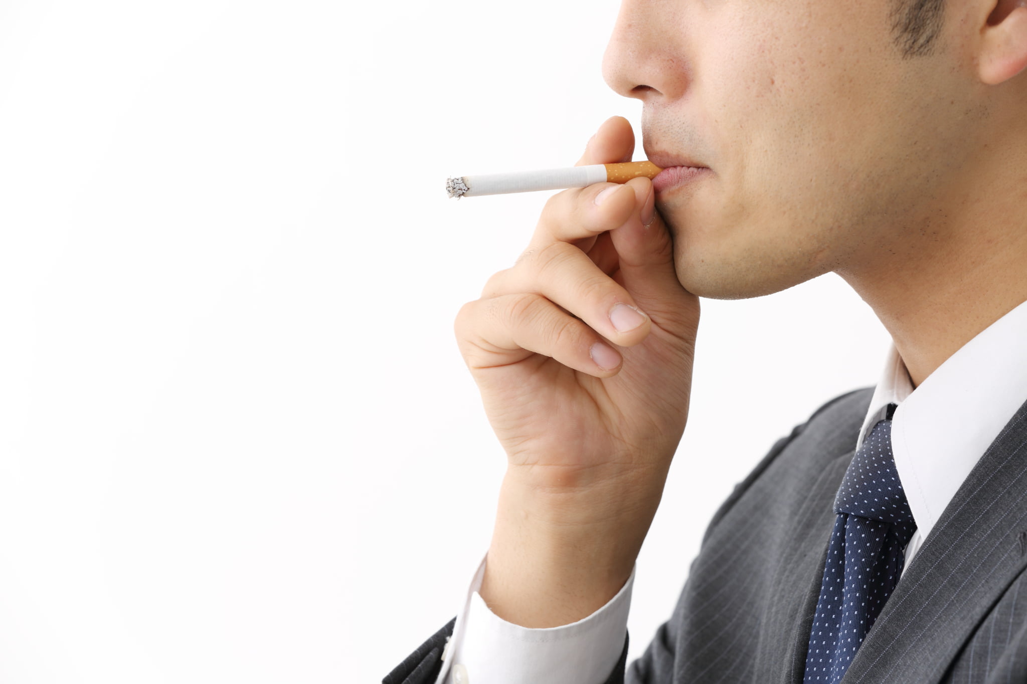 歯周病の原因である喫煙をする男性