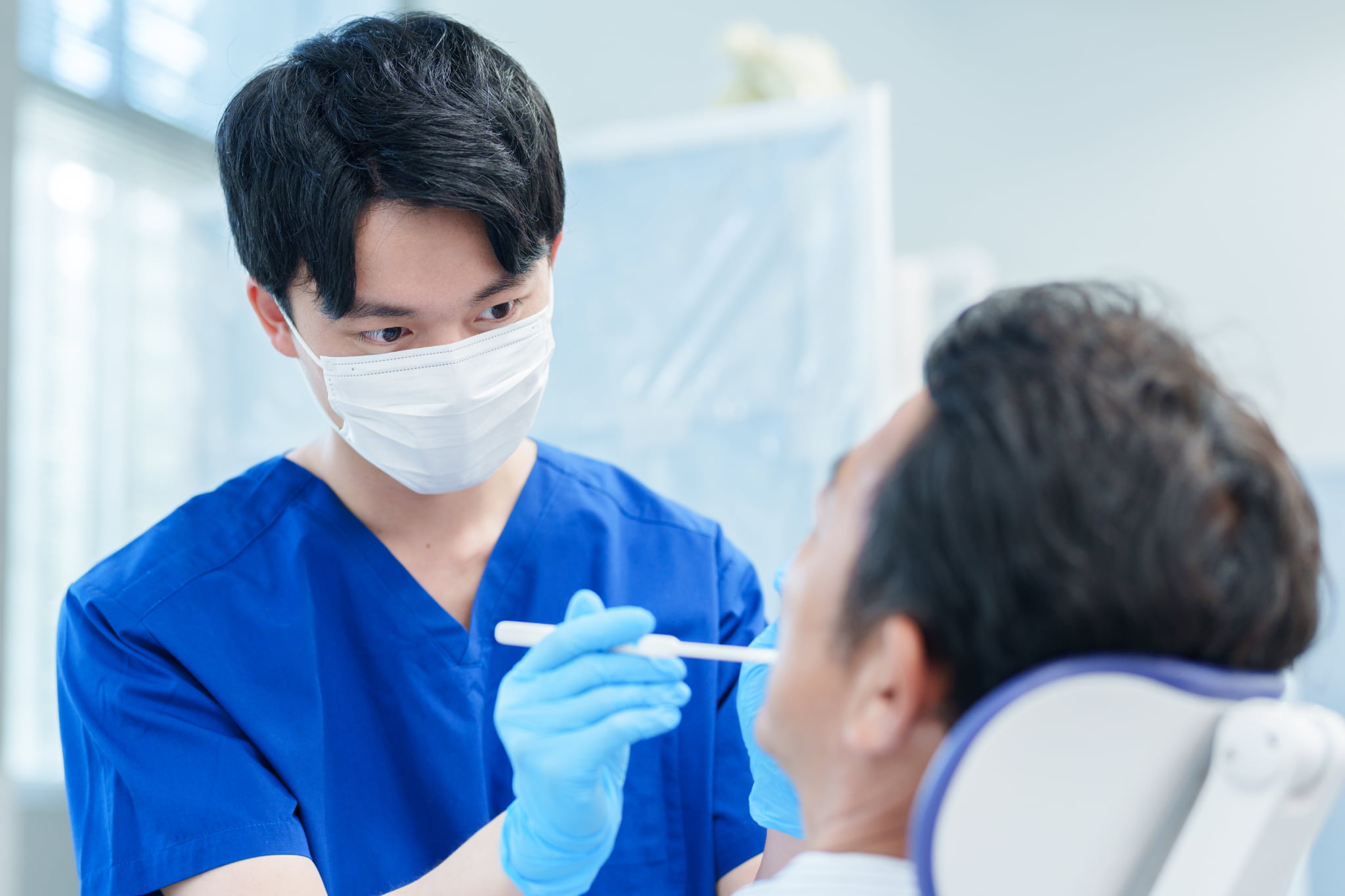 歯科医院で歯周病の治療を受ける男性